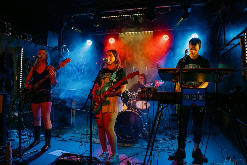 a four piece band perform in a music venue