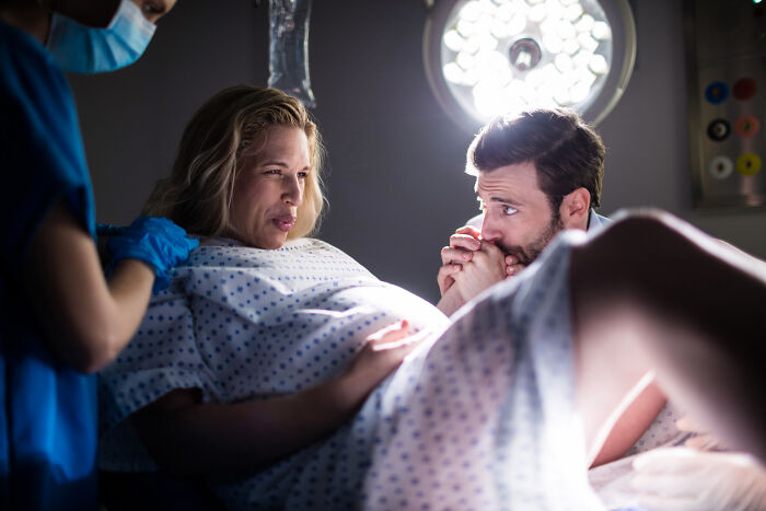 A doctor assists a woman during childbirth, one of the medical procedures doctors do.