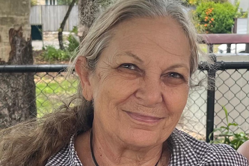 Older woman smiles at the camera
