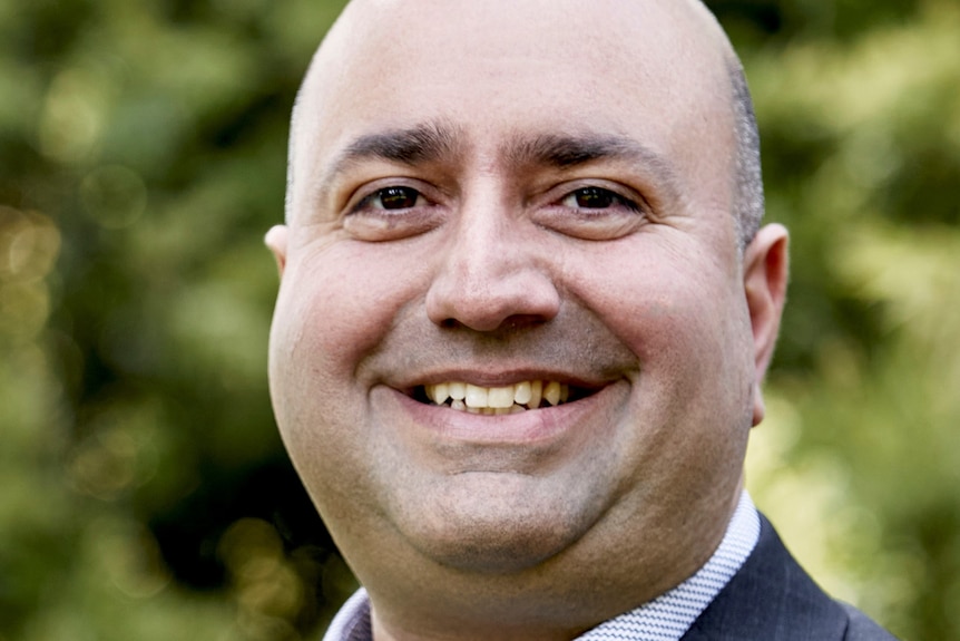 A man smiles at the camera