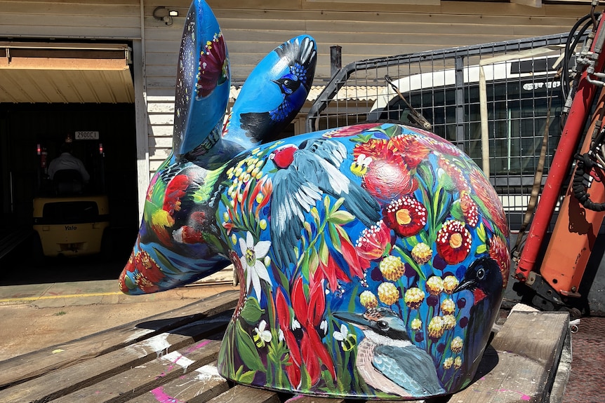 a bilby with a floral design sits on a pallet