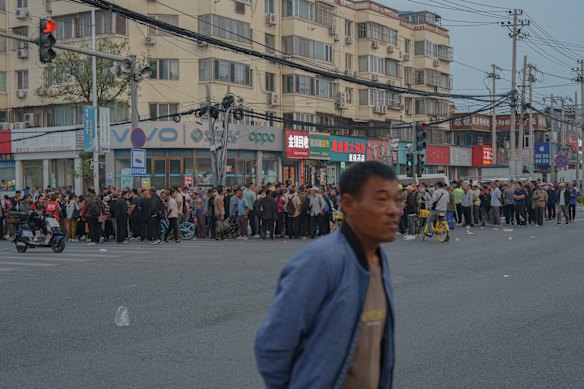 By 5am, this intersection is crowded by migrant workers looking for shifts at factories or on construction sites. 