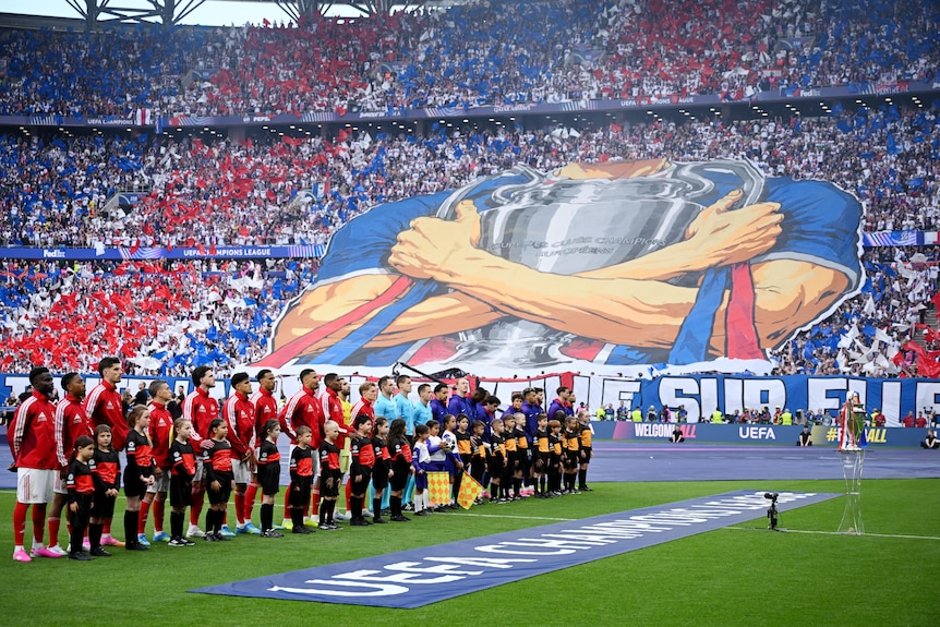 A PSG tifo of a man holding the European Cup