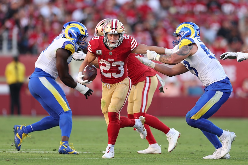 Christian McCaffrey runs through Rams defenders
