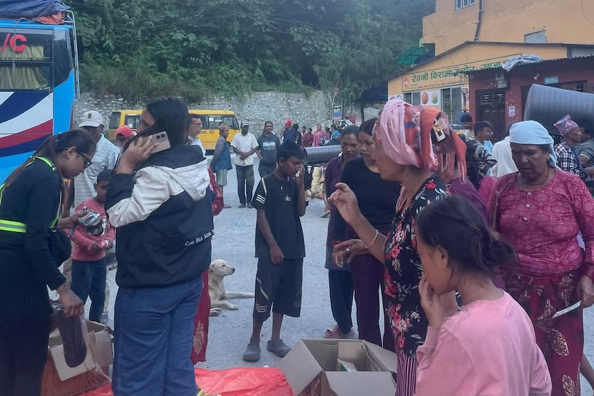 A crowd of residents in a temporary camp.