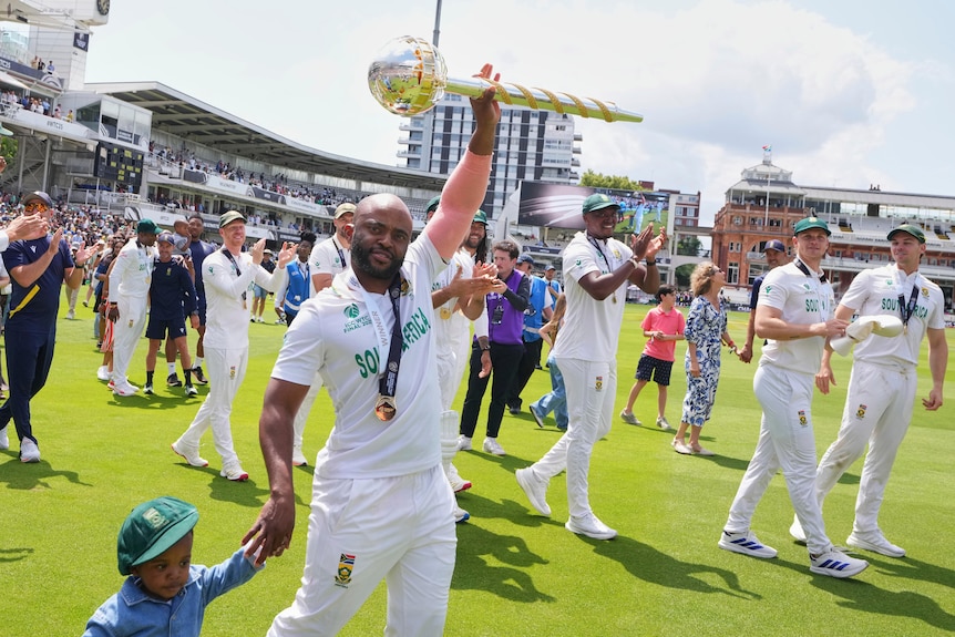 South Africa captain Temba Bavuma holds the mace trophy aloft as he walks around Lord's after the World Test Championship final.