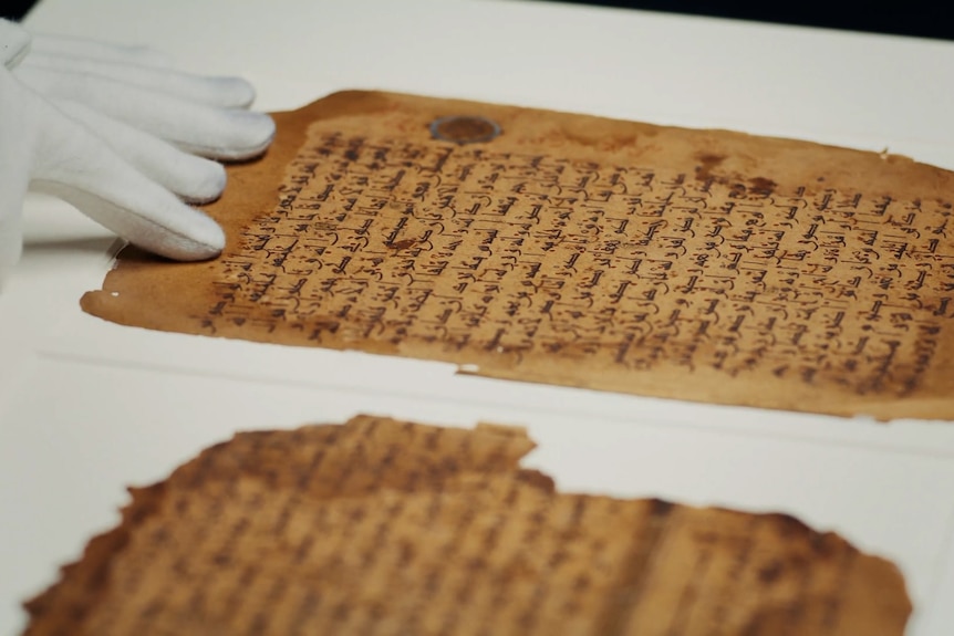 Two pages of calligraphic script written on aged yellow parchment.