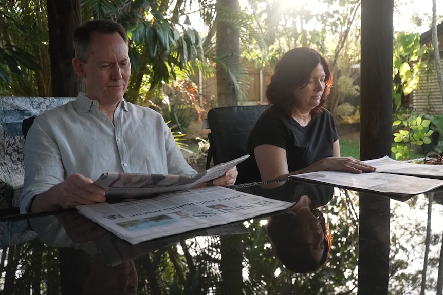 couple reading papers