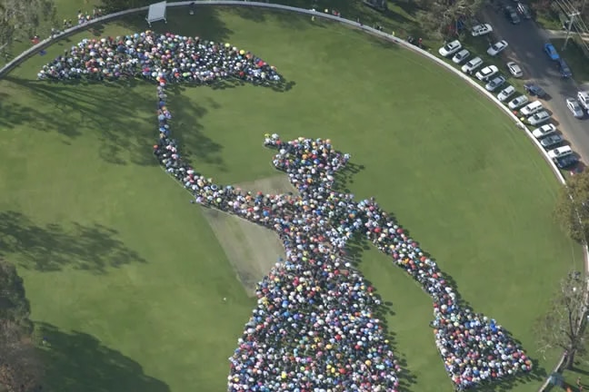 An aerial shot of more than 2,000 raised umbrellas depicting the shape of Mary Poppins.
