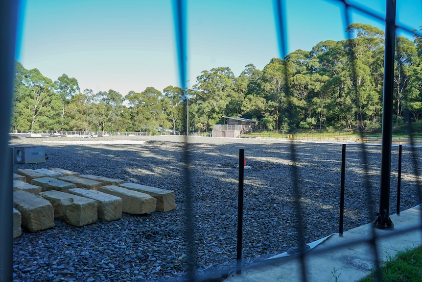 a field of aggregate surrounded by a fence