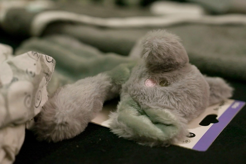 A grey and blue plush toy.