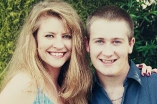 Missing woman Janine Vaughan and her brother Adam smiling at the camera with their arms around each other's shoulders