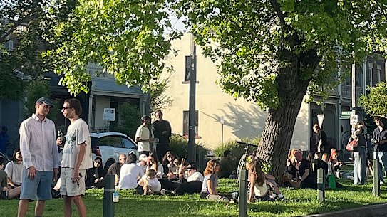 Patrons enjoying the grassy median strip of Canning Street.