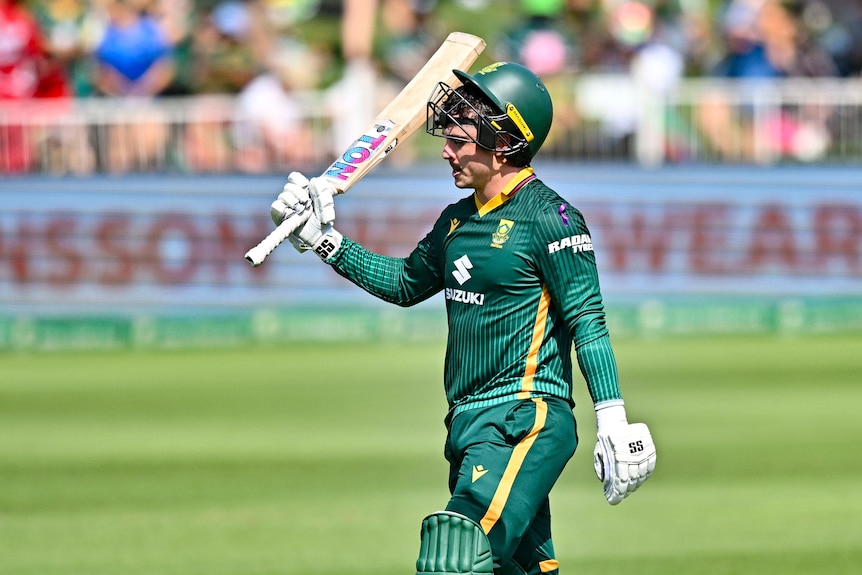 Matthew Breetzke celebrates his century by raising his bat