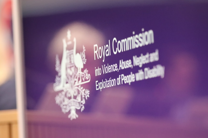 The logo of the disability royal commission is seen on a purple background.