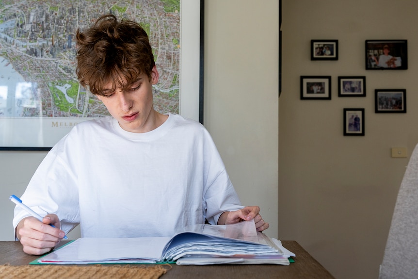A young man studying with a textbook