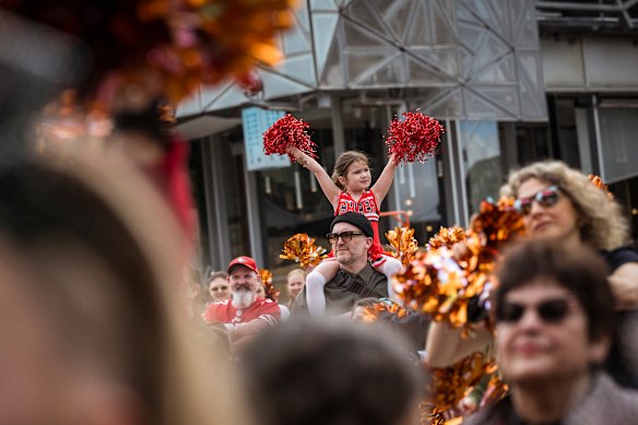 Penny Trotman, 5, sat atop dad Aaron’s shoulders to participate in the record-breaking cheer dance.
