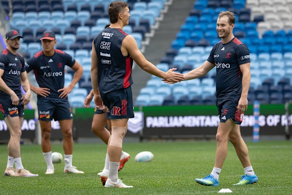 Hugo Savala greets Sam Walker at training on Monday.