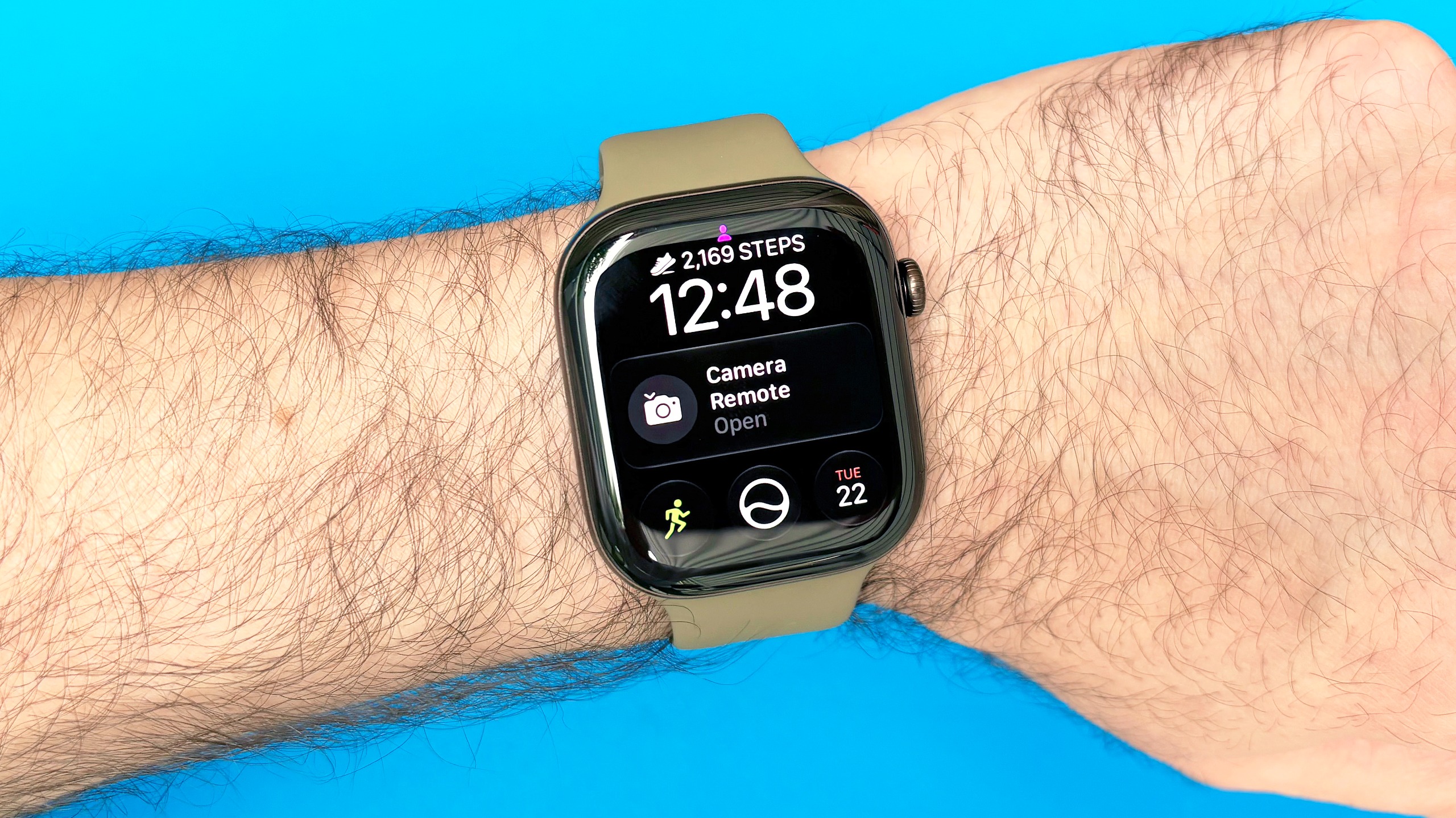 Close-up of the Apple Watch 12 on a user's wrist with the step count widget shown on the watch face