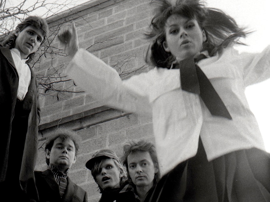 Black and white shot of four male and one female band members of Divinyls.