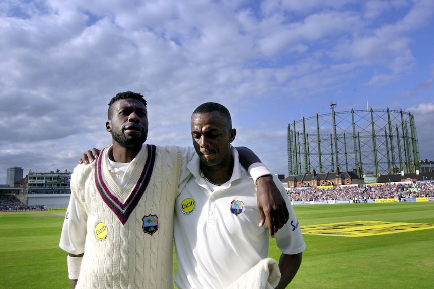 Curtly Ambrose and Courtney Walsh walk off the ground arm in arm