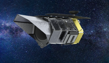 A large space telescope in front of a deep space background.