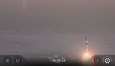 A SpaceX rocket rises out of the clouds and fog during a classified launch to space.