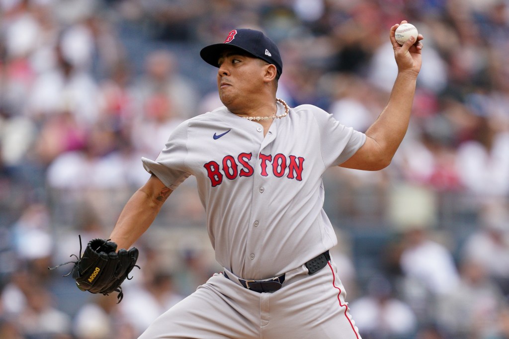 A Boston Red Sox pitcher throws a baseball.