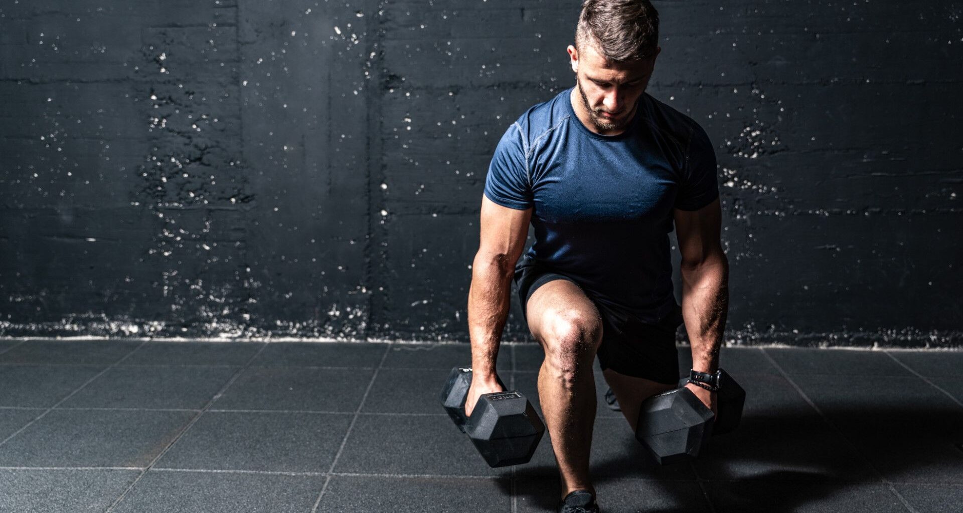 A man doing dumbbell lunges