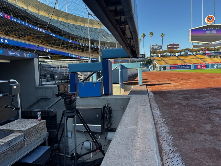 An iPhone on a tripod sits pointed at the field.
