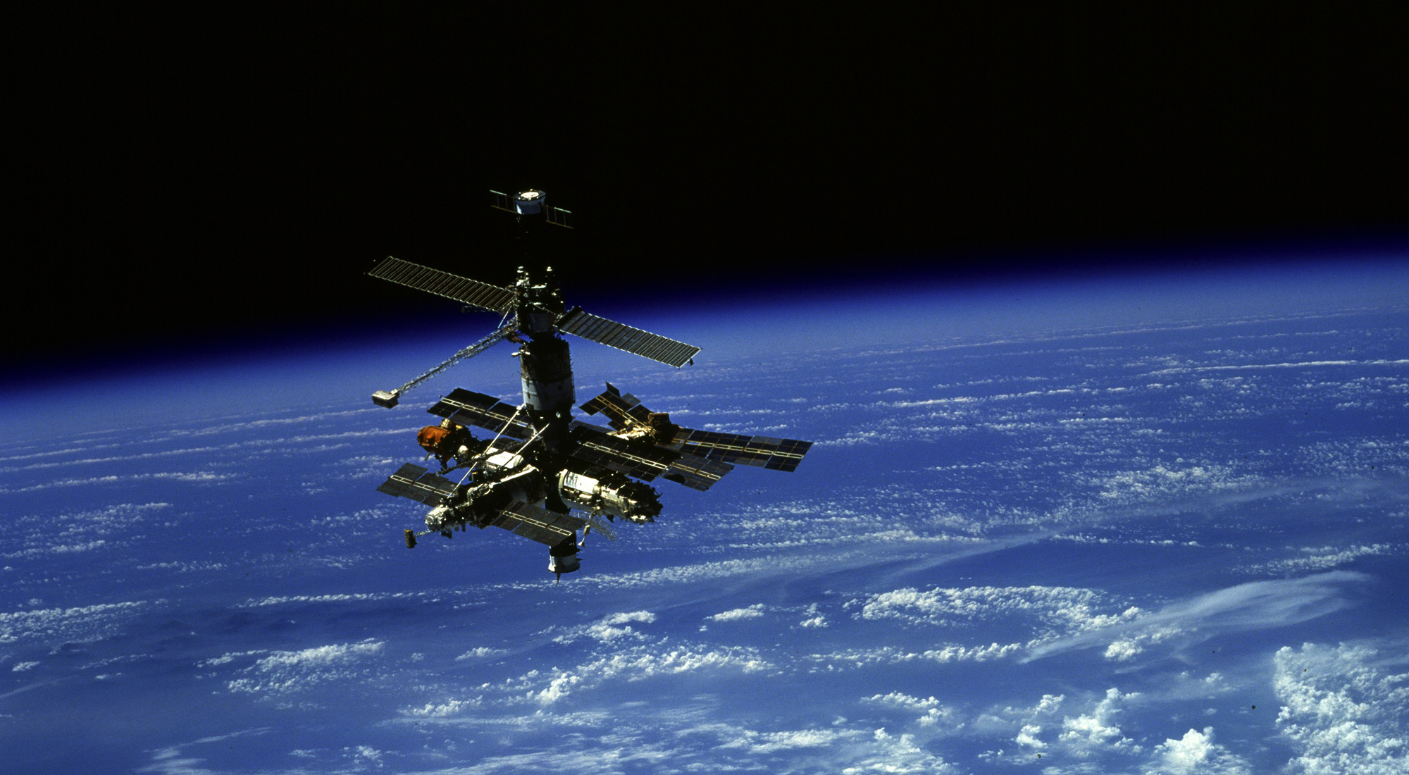 Russia's Space Station Mir is backdropped by a beautiful Earth in this photo by STS-79 shuttle astronauts aboard Atlantis on Sept. 19, 1996 during flyaround maneuvers.