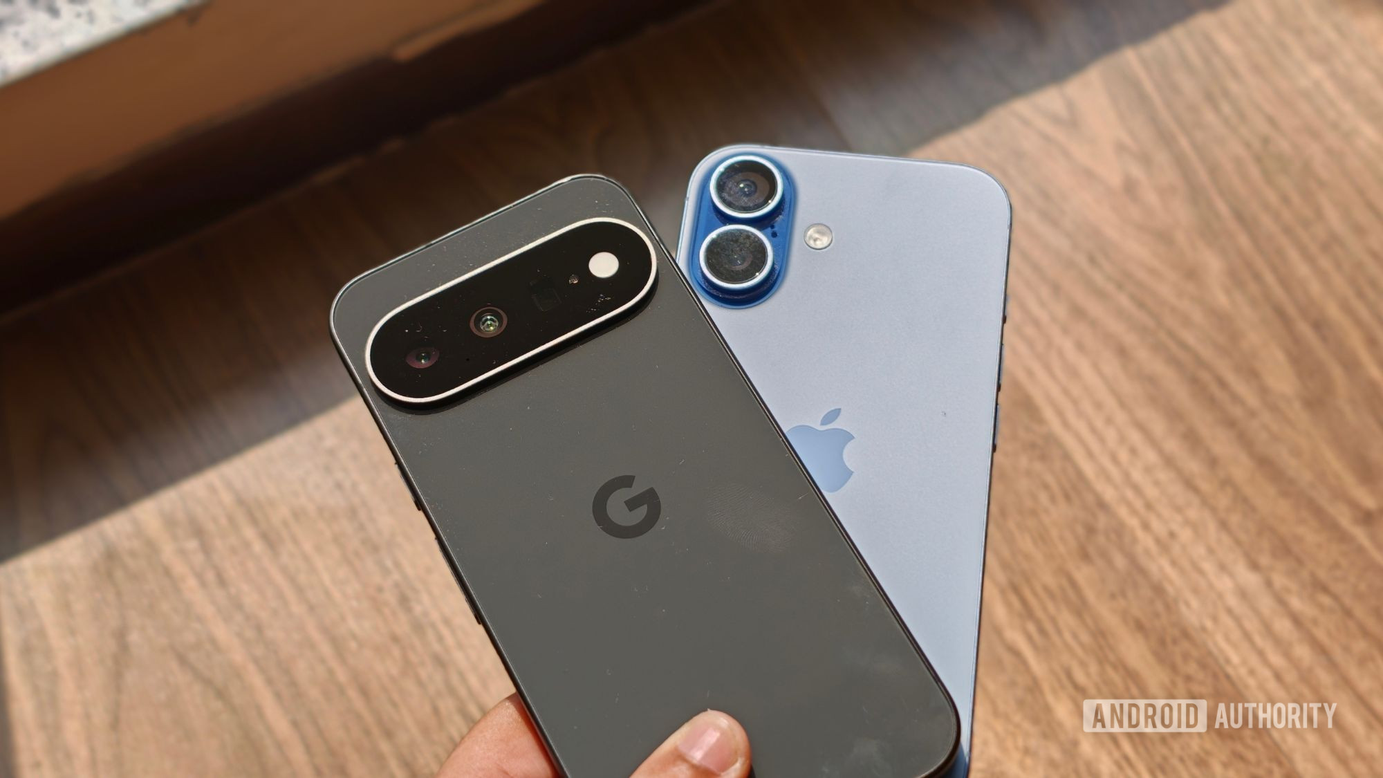 Pixel 11 over iPhone 17 in a person's hand