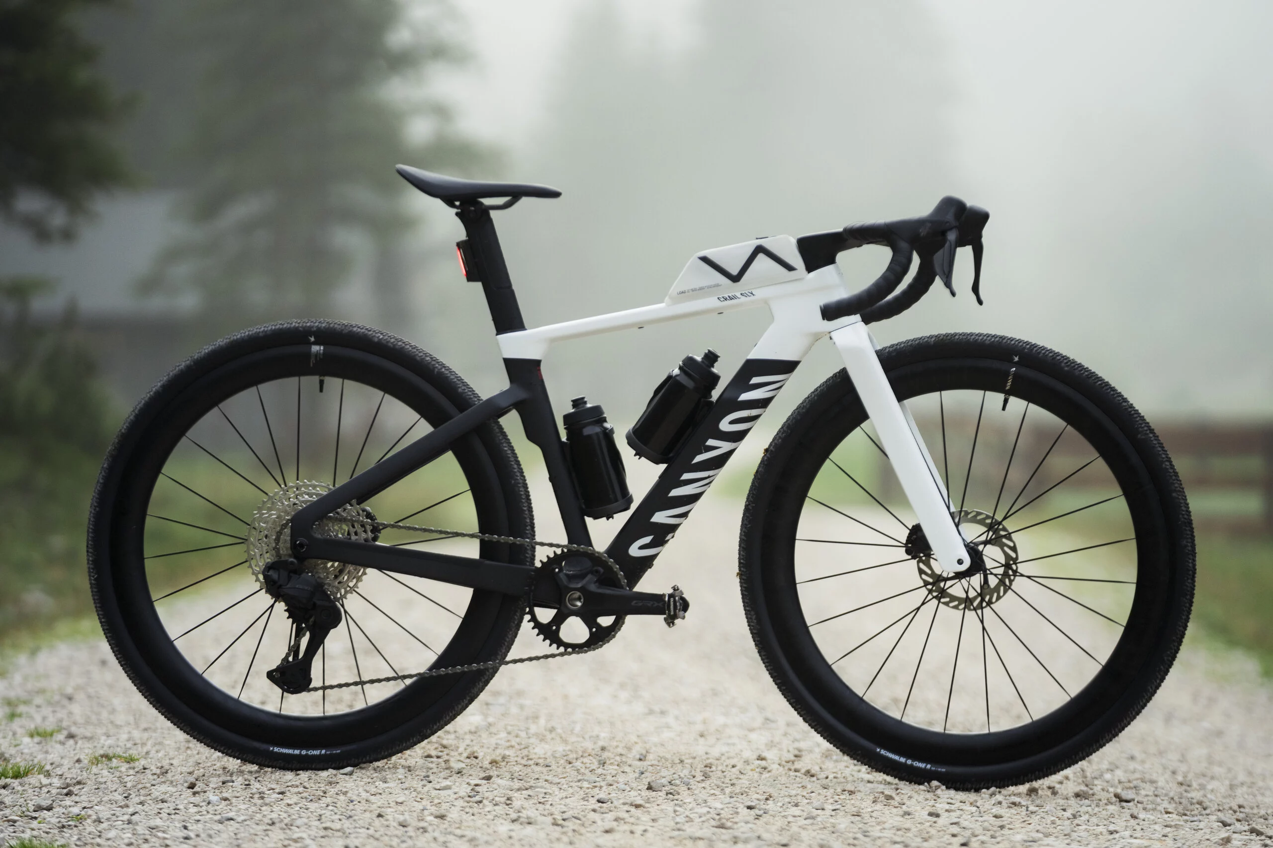 A black and white Canyon Grail CF SLX on a gravel path