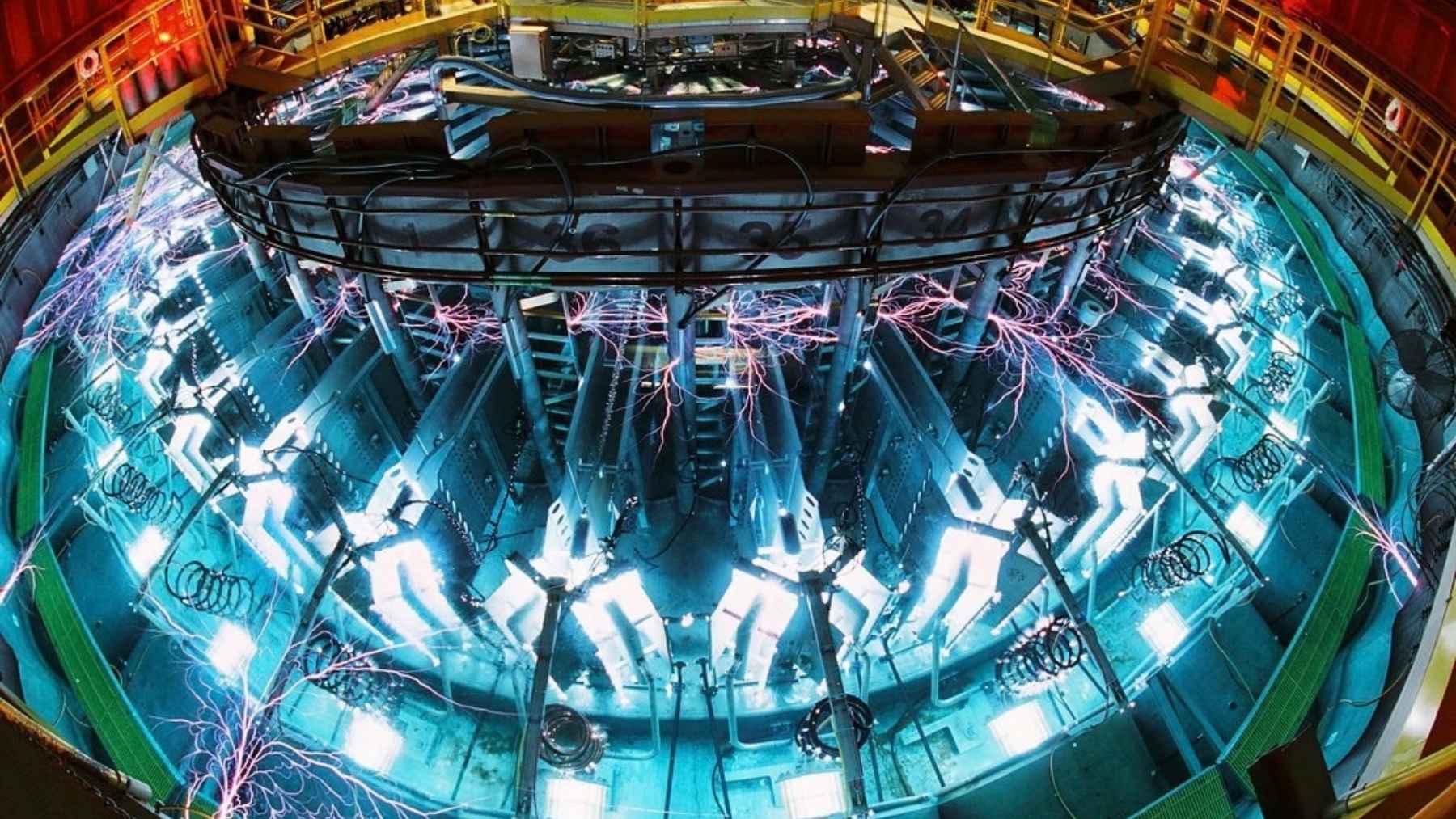 A 20-foot vacuum chamber in Albuquerque takes 26 million amps from 2,160 capacitors in about 100 billionths of a second, around 200 times a year, each shot shaking the ground like a small earthquake, and the lab that runs it wants one 10 times bigger