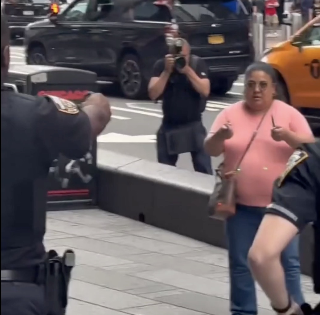 Police officers confront Pamela Cisneros on Monday after she stabbed two people in Times Square. Credit: X