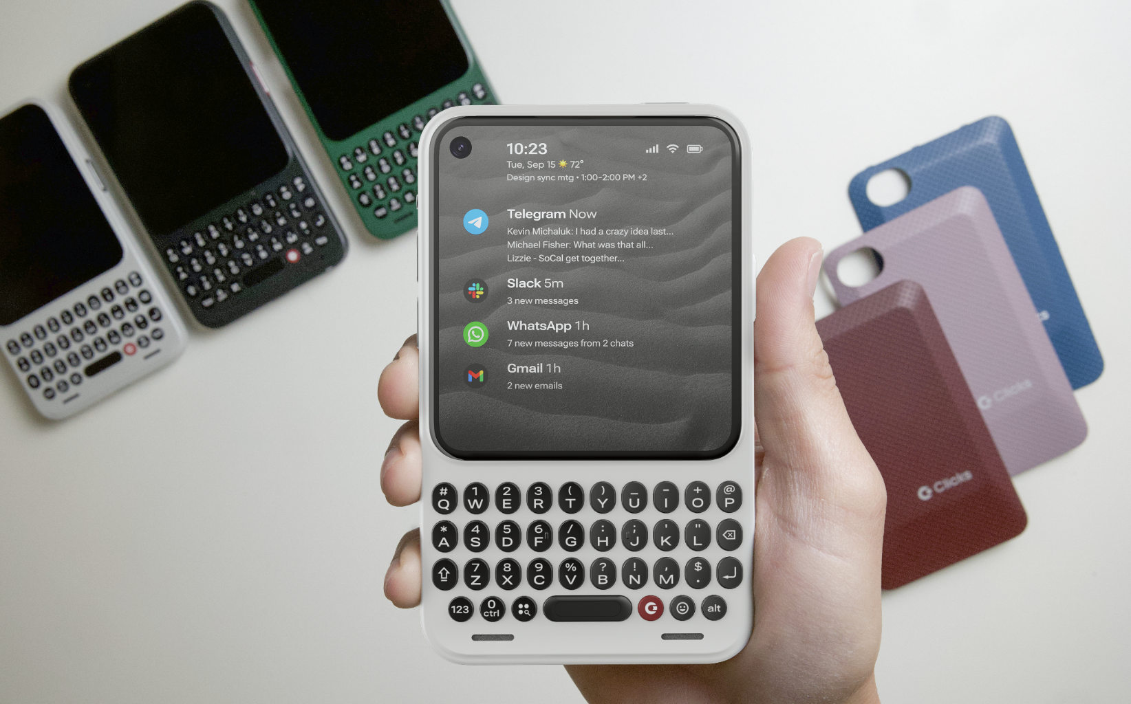 A hand holding the Clicks Communicator