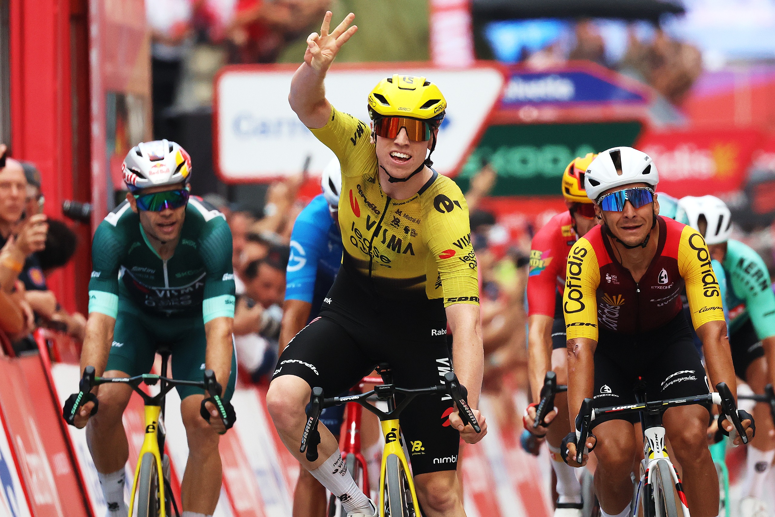 Matthew Brennan holds up three fingers after winning stage 11 of the Vuelta a Espana 2026
