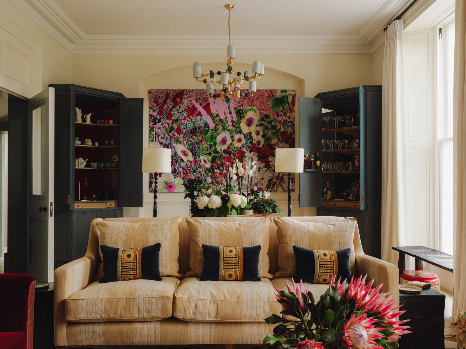 Image may contain Architecture Building Furniture Indoors Living Room Room Home Decor Flower and Flower Arrangement