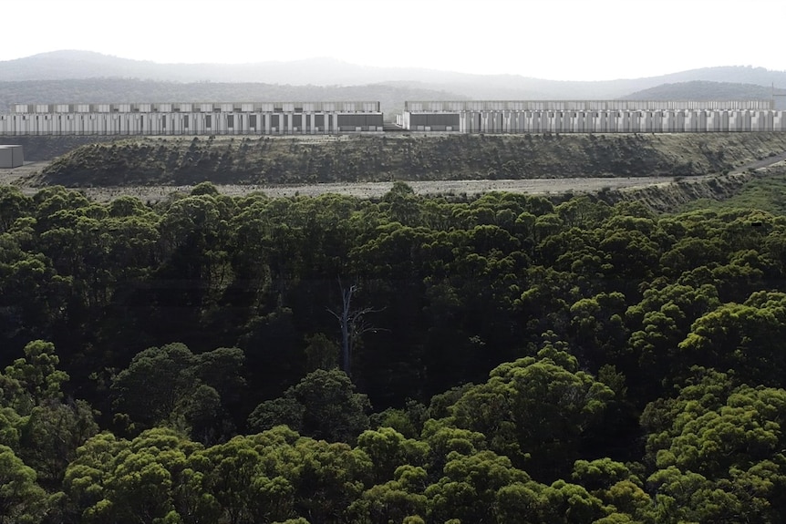 A computer render of a long, low beige coloured building among trees