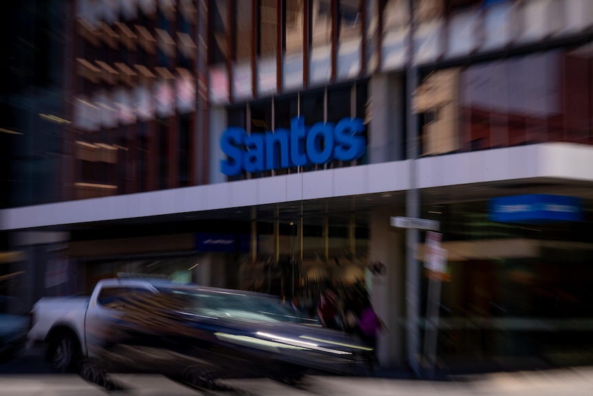 A blurry image of Santos signage on an office building