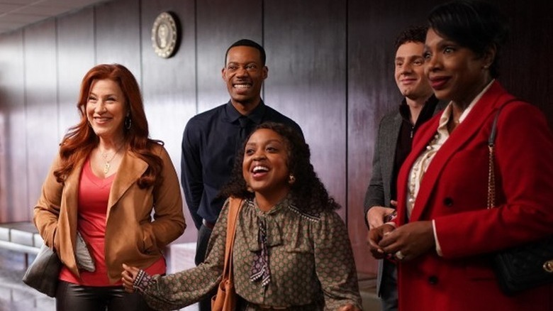 Janine, Gregory, Melissa, Jacob, and Barbara smile at someone in 