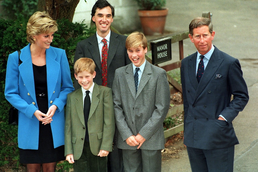 a group of people, including Princess Diana, stand outside a gate labelled 'Manor House'.
