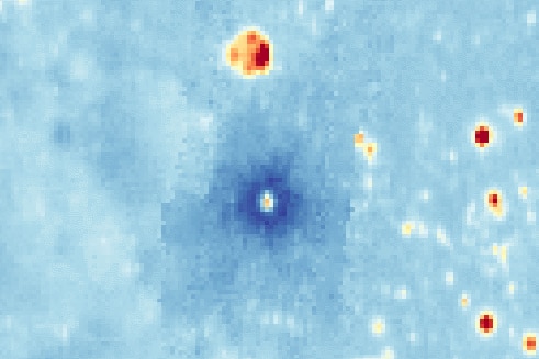 A thermal image shown msotly in blue, dotted with red-orange circles and one notably dark blue circle in the middle.