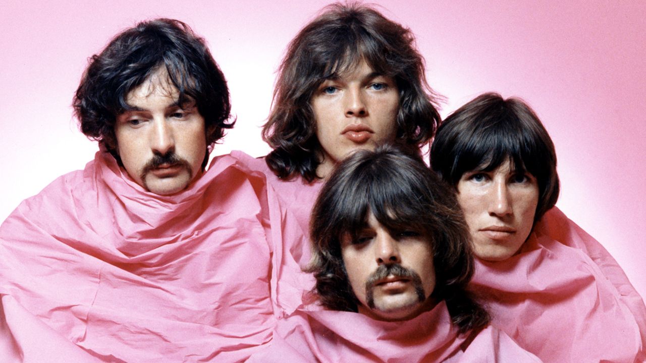 Pink Floyd pose shrouded in pink in August of 1968 in Los Angeles. (L-R) Nick Mason, Dave Gilmour, Rick Wright (center front), Roger Waters. (Photo by Michael Ochs Archives/Getty Images)