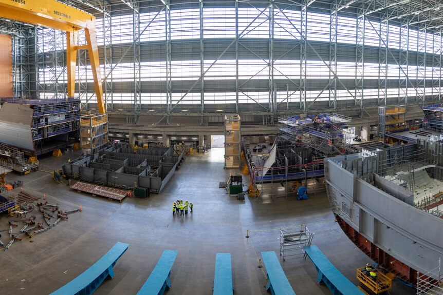 A panorama shot of a shipyard where equipment and assembly materials can be seen.
