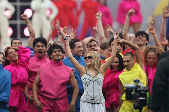A colourful crowd of dancers surround Kylie during her set.