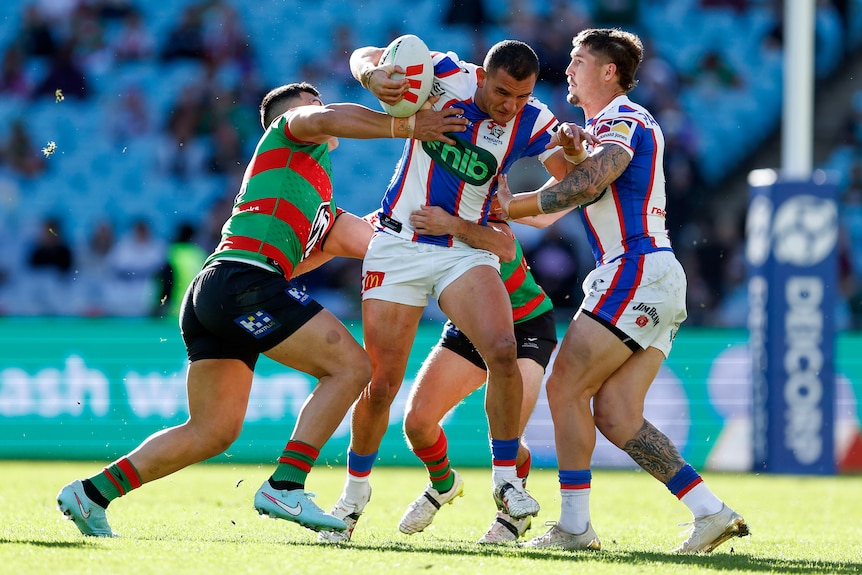 Mat Croker runs the ball during a rugby league match.