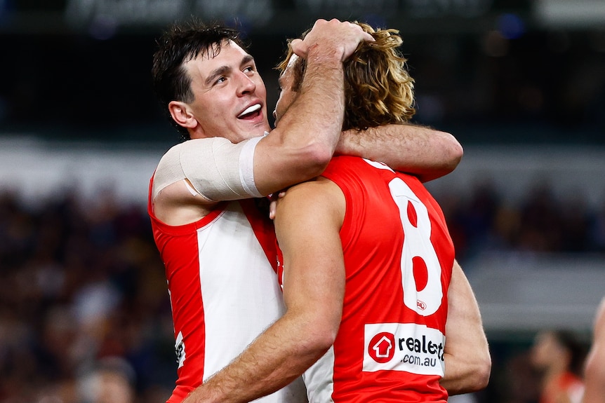 Errol Gulden and James Rowbottom share a hug on the field
