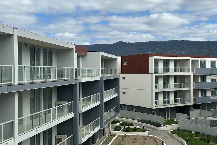 image of apartment building with mountains in the background