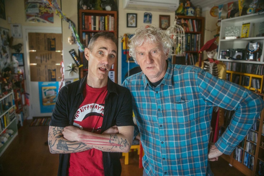 Andy and Terry stand in a colourful room